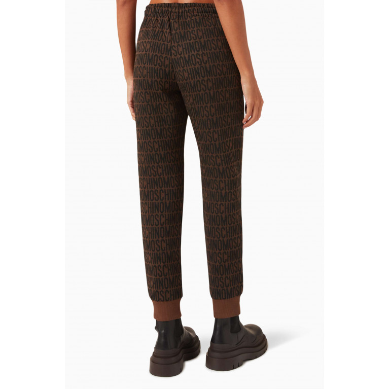 Moschino - All-over Logo Sweatpants in Cotton-blend Brown